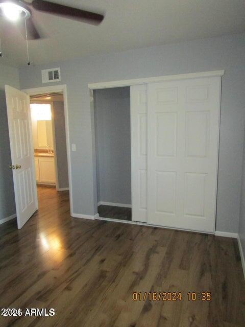 21622 N 23rd Ave Unit B 304, Phoenix, AZ 85027 - unfurnished bedroom featuring baseboards, wood finished floors, visible vents, and a closet