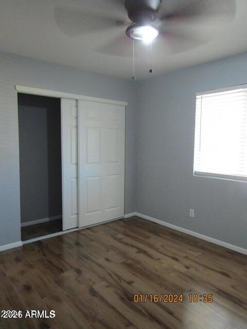21622 N 23rd Ave Unit B 304, Phoenix, AZ 85027 - unfurnished bedroom featuring baseboards, wood finished floors, and a closet