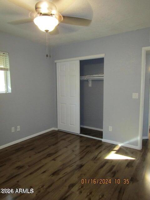 21622 N 23rd Ave Unit B 304, Phoenix, AZ 85027 - unfurnished bedroom with baseboards, wood finished floors, and a closet