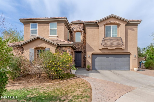 120 E Concorda Dr, Tempe, AZ 85282 - mediterranean / spanish-style home with a tiled roof, an attached garage, stone siding, stucco siding, and driveway