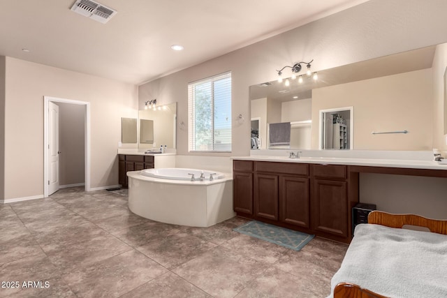 120 E Concorda Dr, Tempe, AZ 85282 - bathroom with visible vents, a bath, baseboards, a sink, and two vanities