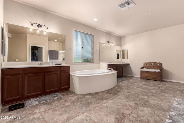 120 E Concorda Dr, Tempe, AZ 85282 - bathroom featuring visible vents, a bath, baseboards, a sink, and two vanities