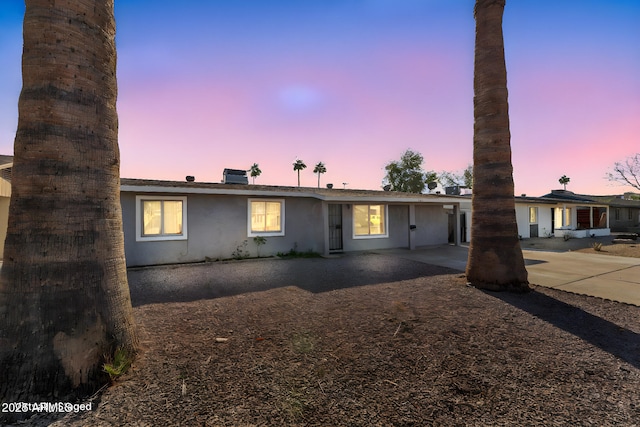 view of front of property with stucco siding and a patio area