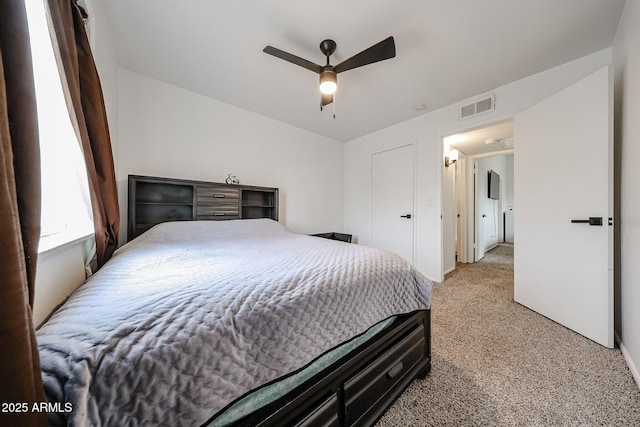 bedroom with light carpet and ceiling fan