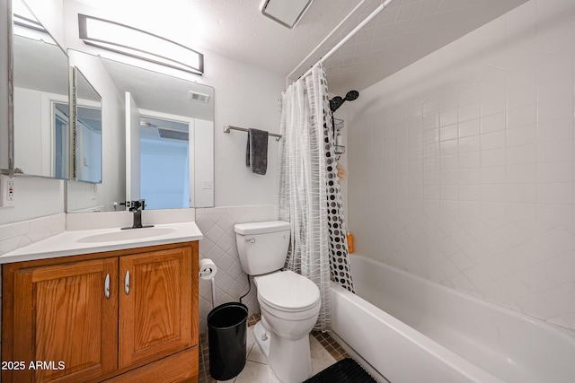 full bathroom featuring tile walls, tile patterned flooring, vanity, toilet, and shower / bath combo