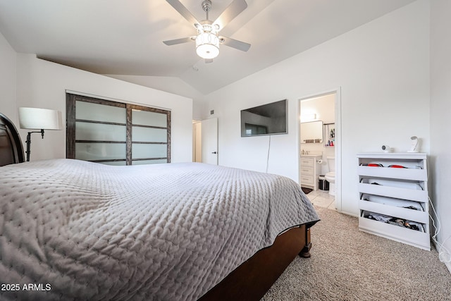 bedroom featuring lofted ceiling, light colored carpet, ceiling fan, and ensuite bathroom