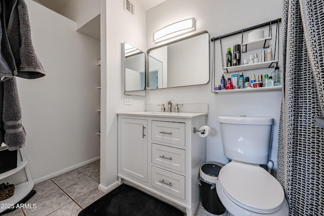 bathroom featuring vanity, tile patterned flooring, and toilet