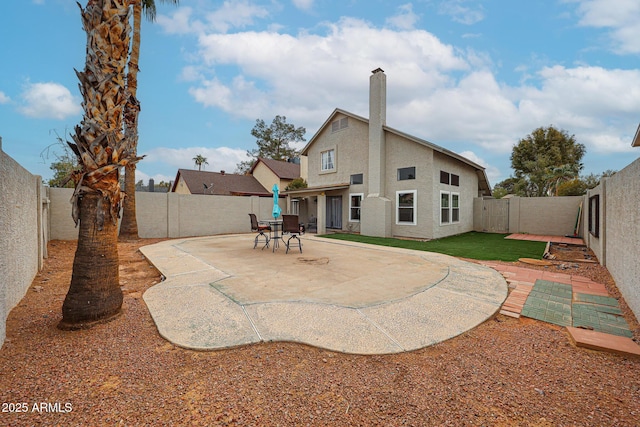 back of house with a patio