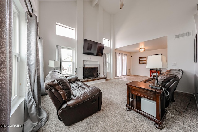 living room featuring high vaulted ceiling and carpet floors