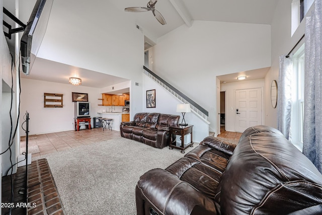 tiled living room featuring sink, beam ceiling, high vaulted ceiling, and ceiling fan