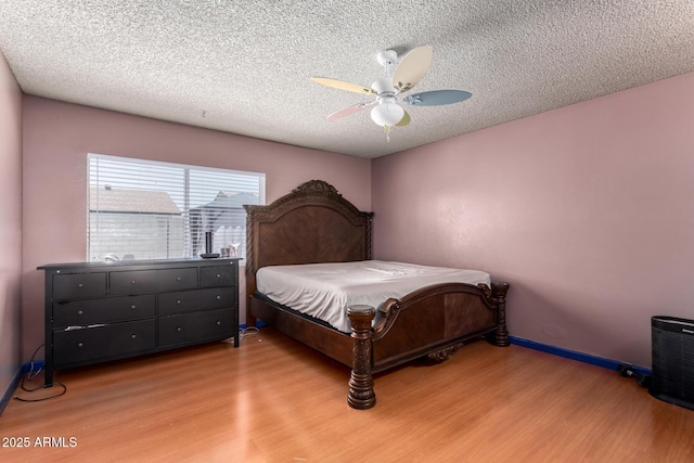 5432 W Sunnyside Dr, Glendale, AZ 85304 - bedroom featuring wood finished floors, a textured ceiling, and ceiling fan