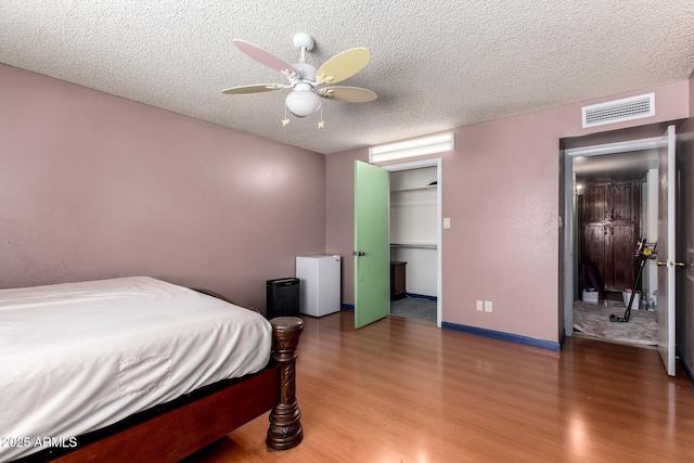 5432 W Sunnyside Dr, Glendale, AZ 85304 - bedroom with wood finished floors, a textured ceiling, and ceiling fan