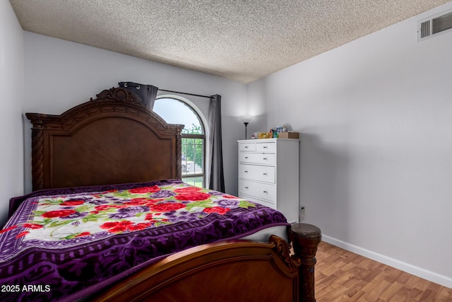 5432 W Sunnyside Dr, Glendale, AZ 85304 - bedroom featuring light wood finished floors and a textured ceiling