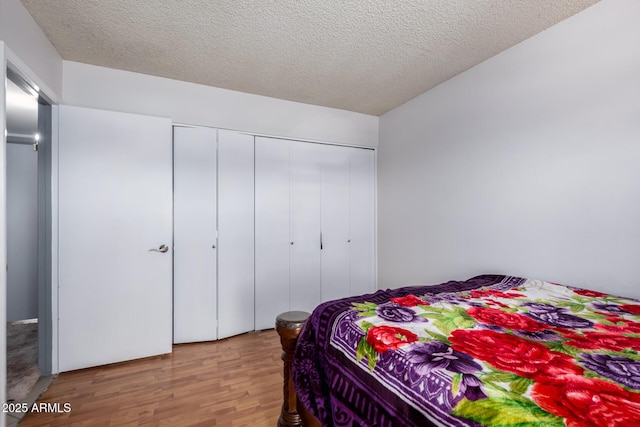 5432 W Sunnyside Dr, Glendale, AZ 85304 - bedroom featuring wood finished floors, a closet, and a textured ceiling