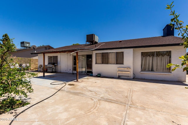 5432 W Sunnyside Dr, Glendale, AZ 85304 - back of house featuring a patio area, a chimney, and roof with shingles