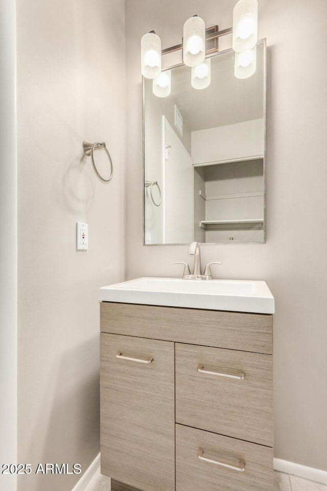 bathroom with vanity and baseboards