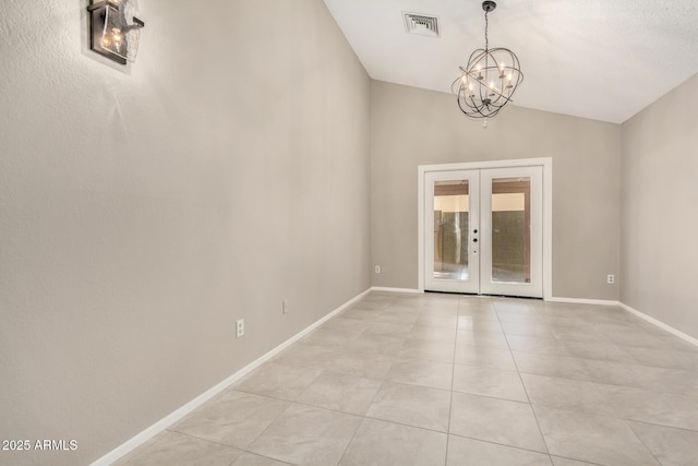 unfurnished room featuring light tile patterned floors, a chandelier, lofted ceiling, baseboards, and french doors