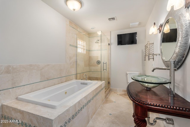 bathroom with a sink, a whirlpool tub, a stall shower, toilet, and tile patterned floors