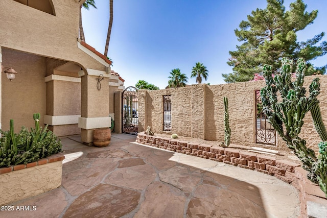 view of patio / terrace with a gate and fence