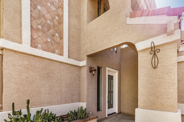 doorway to property with stucco siding