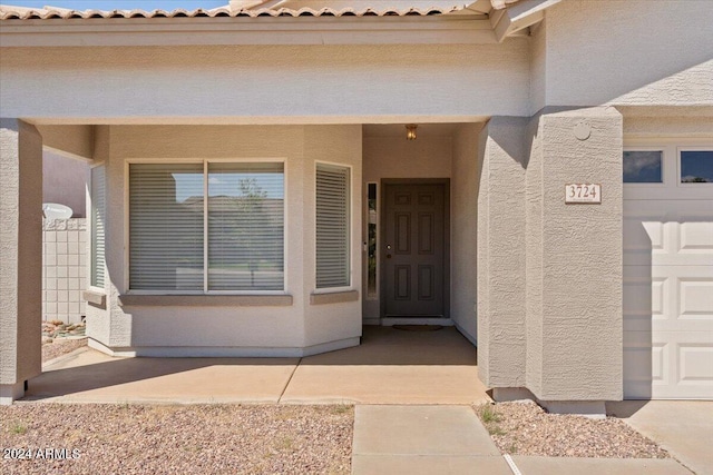 view of exterior entry featuring a garage