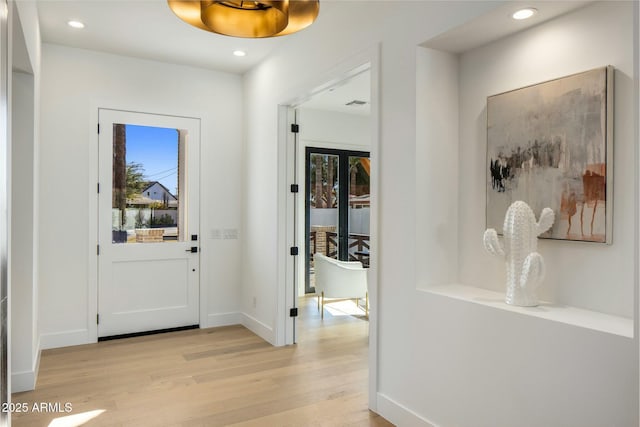 foyer entrance with plenty of natural light and light wood-type flooring