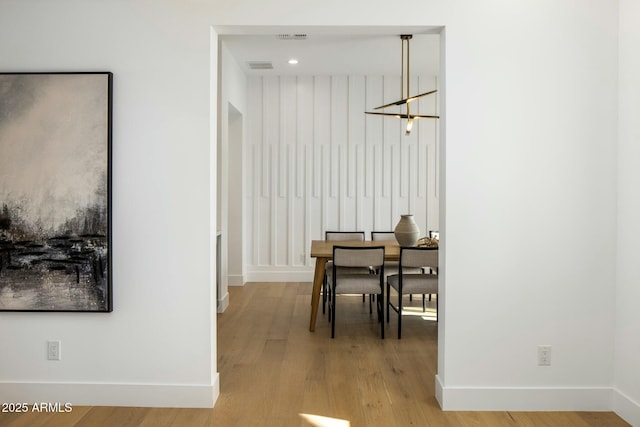 dining room with a chandelier and light hardwood / wood-style floors