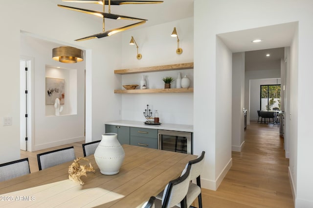 dining room featuring wine cooler and light hardwood / wood-style floors