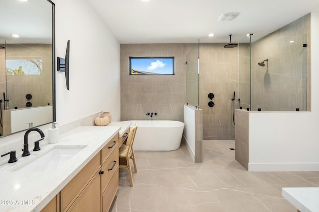 bathroom with independent shower and bath, tile patterned flooring, and vanity