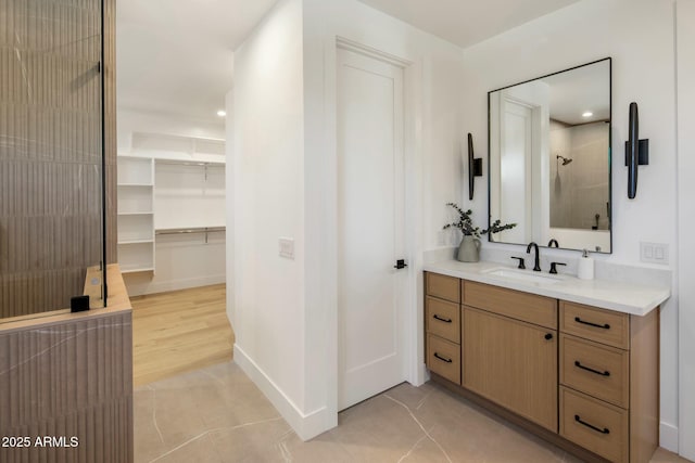 bathroom featuring a shower, tile patterned floors, and vanity