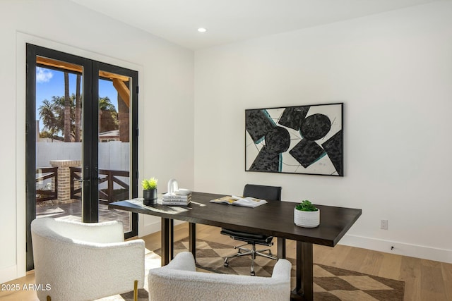 office space with french doors and hardwood / wood-style flooring