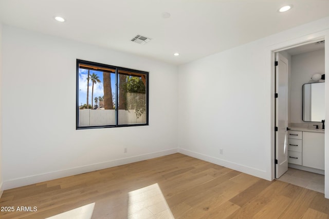 unfurnished bedroom with light wood-type flooring