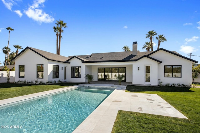 back of house with a patio area and a yard