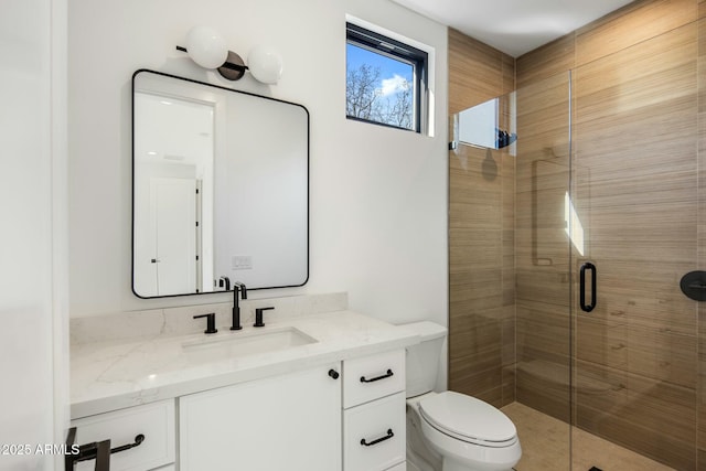 bathroom with toilet, a shower with shower door, and vanity