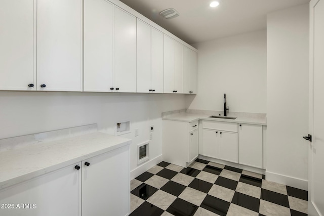 laundry area with sink, hookup for a washing machine, electric dryer hookup, and cabinets