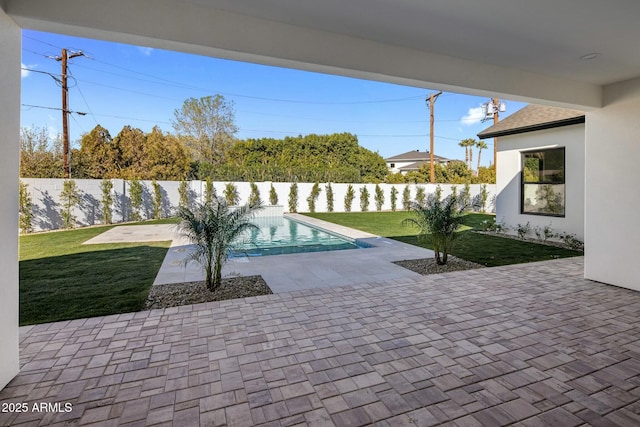 view of pool with a patio area and a yard