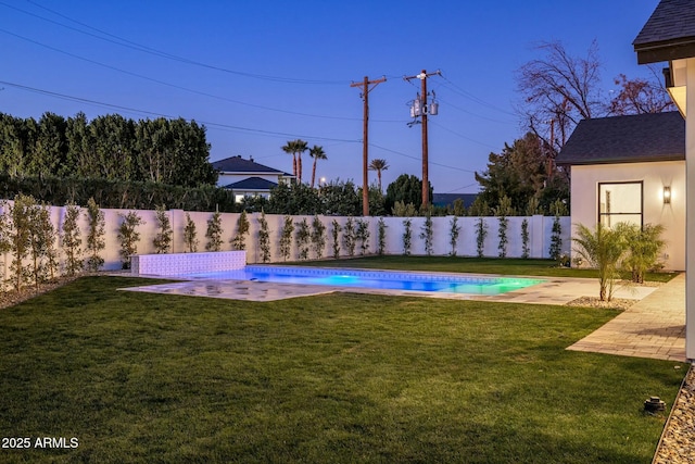 view of yard featuring a fenced in pool and a patio