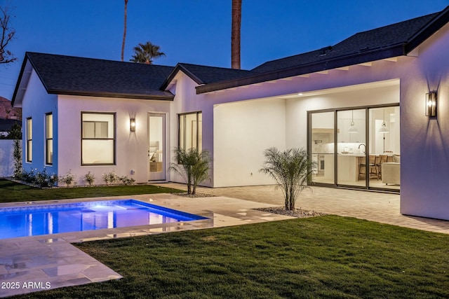 back of property featuring a yard and a patio