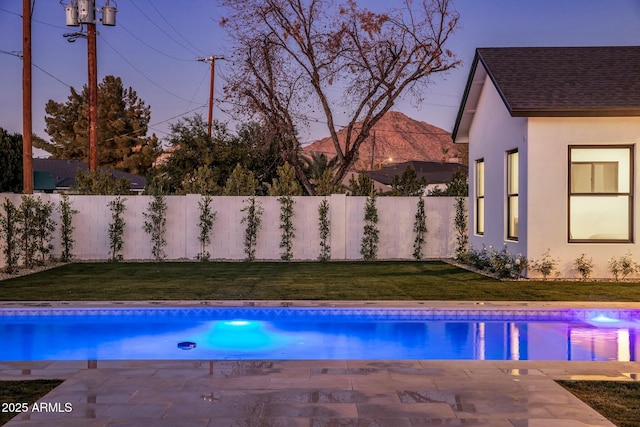 view of pool featuring a lawn and a patio