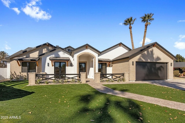 view of front of house with a garage and a front lawn