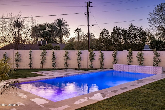 pool at dusk with a yard