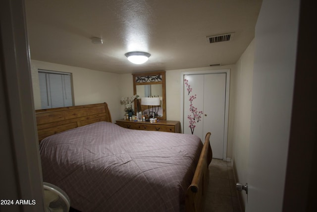 bedroom with a closet and a textured ceiling