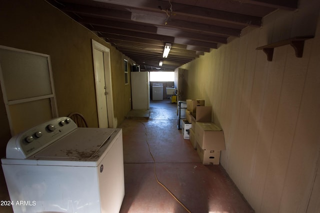 basement with washer / clothes dryer, wooden walls, and sink