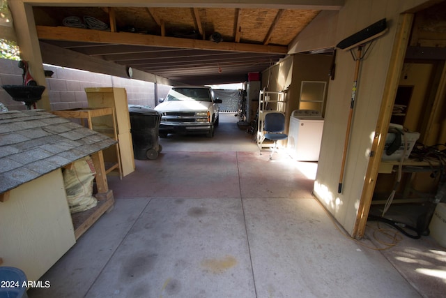 garage with washer / clothes dryer and a carport