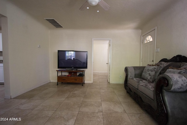 tiled living room featuring ceiling fan