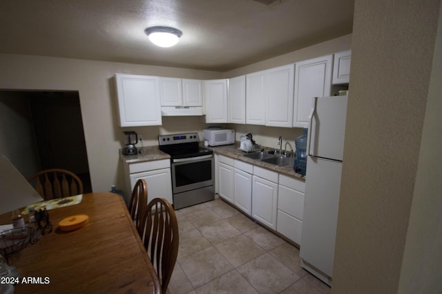 kitchen with light tile patterned floors, white appliances, white cabinetry, and sink