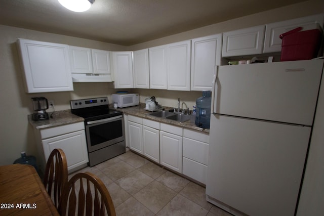 kitchen with sink, white cabinets, white appliances, and light tile patterned floors