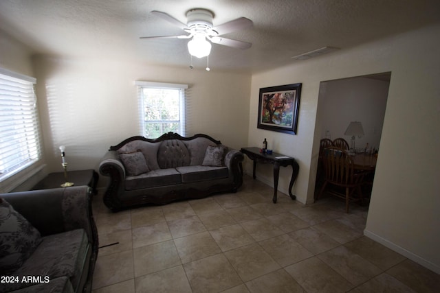 living room featuring ceiling fan and light tile patterned flooring