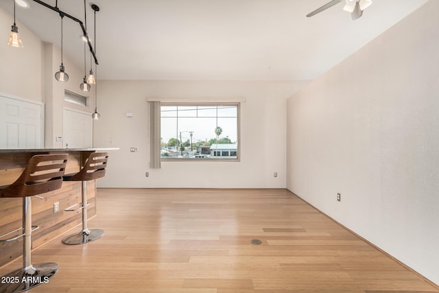 interior space with light wood finished floors and a ceiling fan