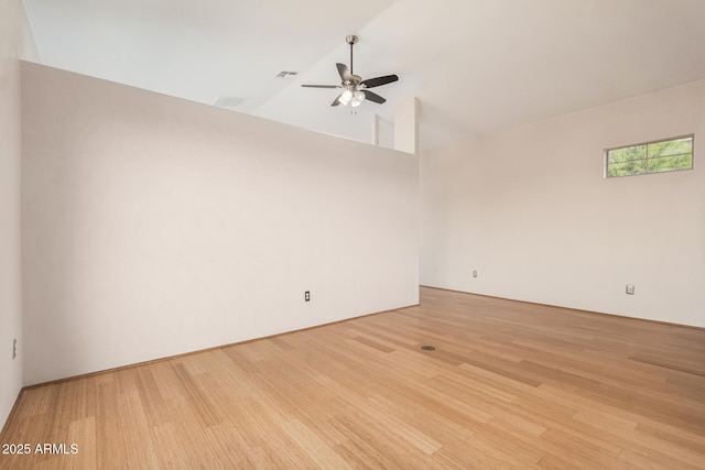 spare room featuring light wood-style floors, ceiling fan, and high vaulted ceiling